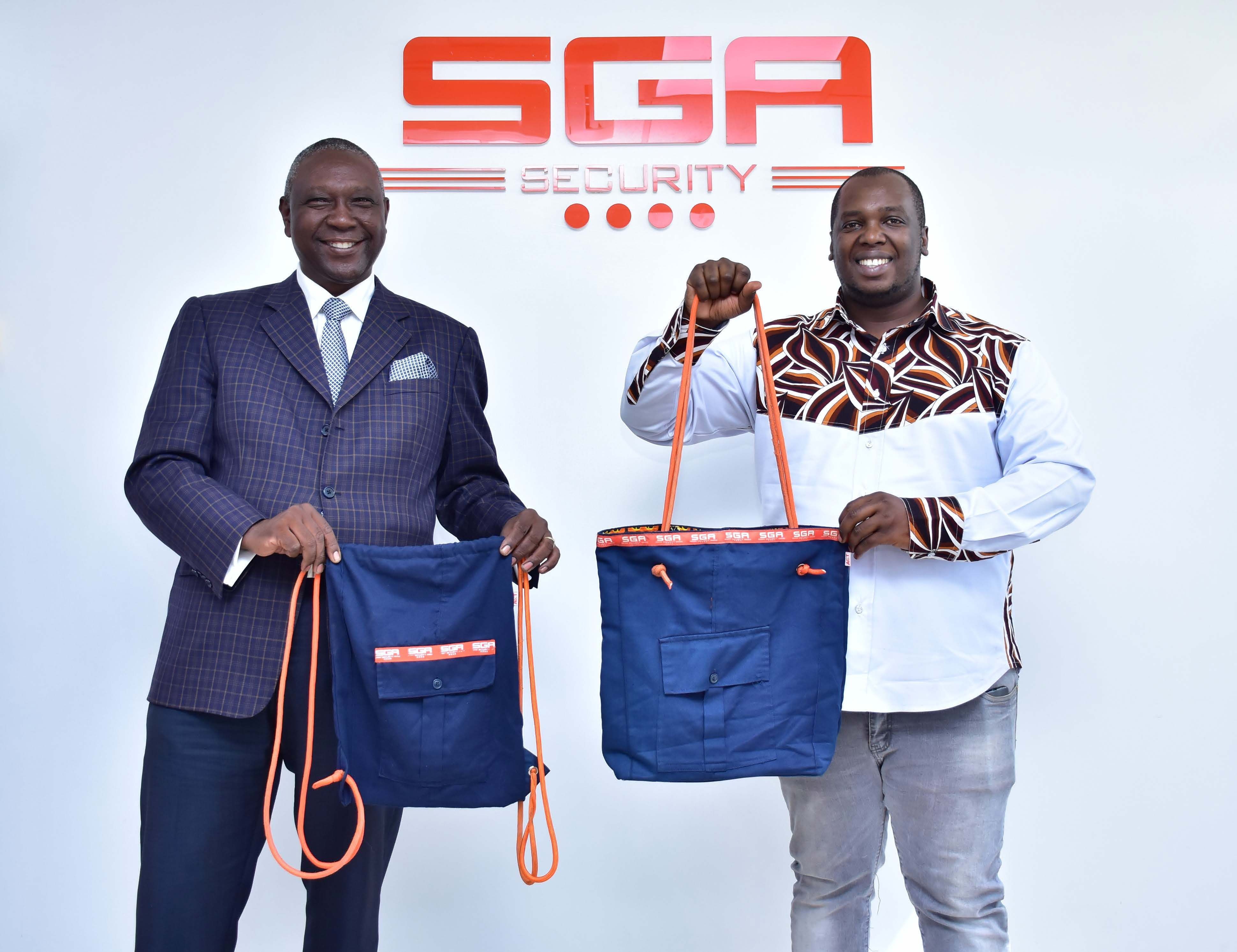 Two men posing with bags