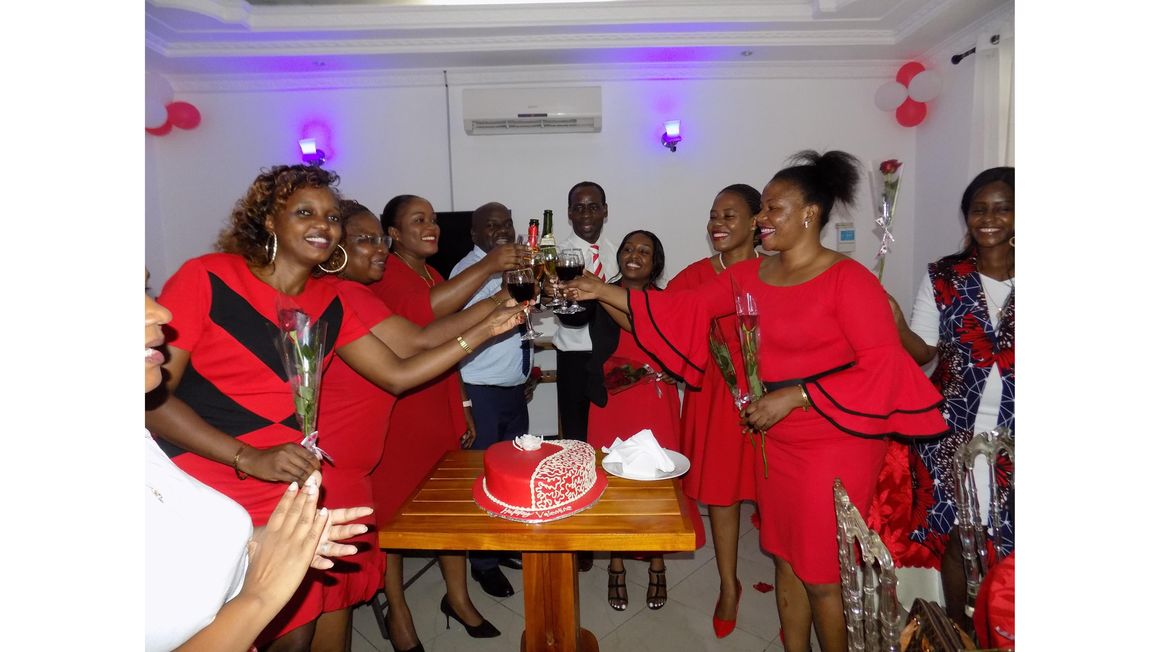 People dressed in red making a toast