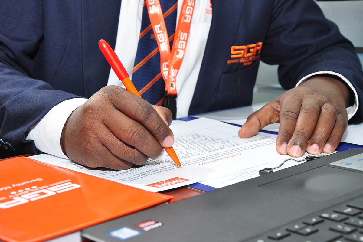 SGA security personnel writing on paper