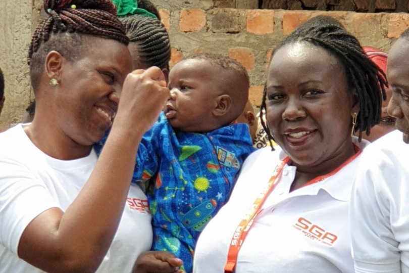 Two women wearing SGA security t-shirts laughing together