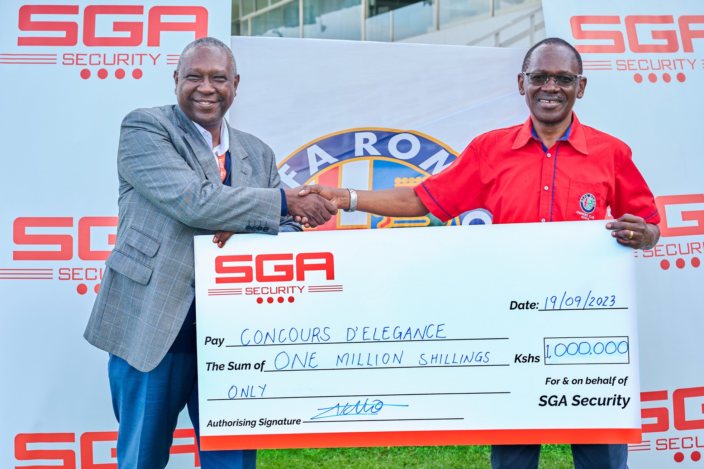 Two men holding a cheque