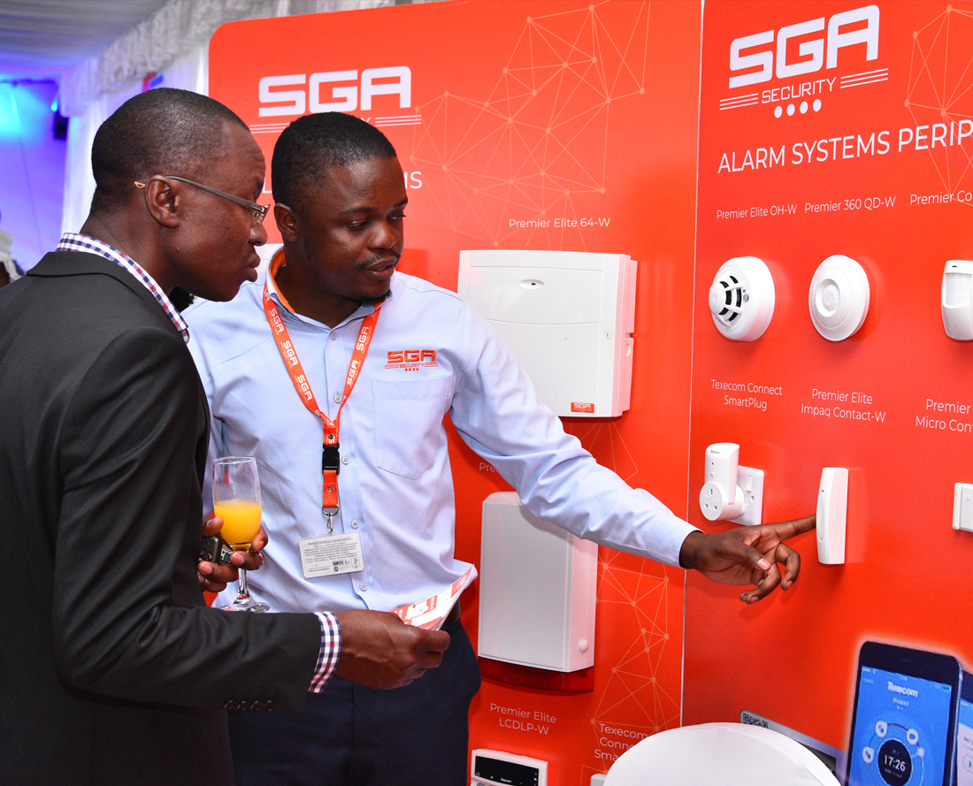 man explaining the alarm systems on display